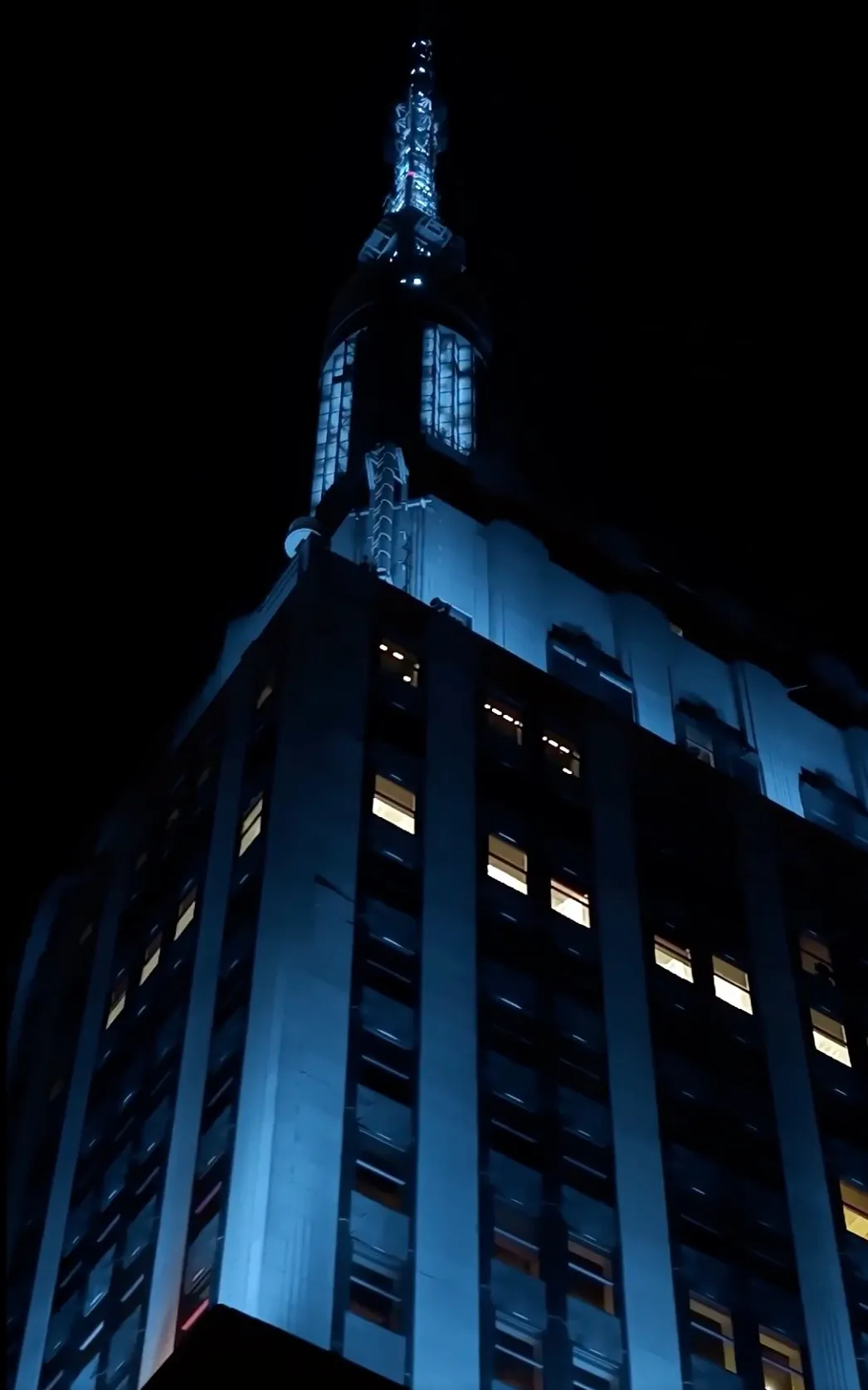 Empire State Building lit in blue at night.