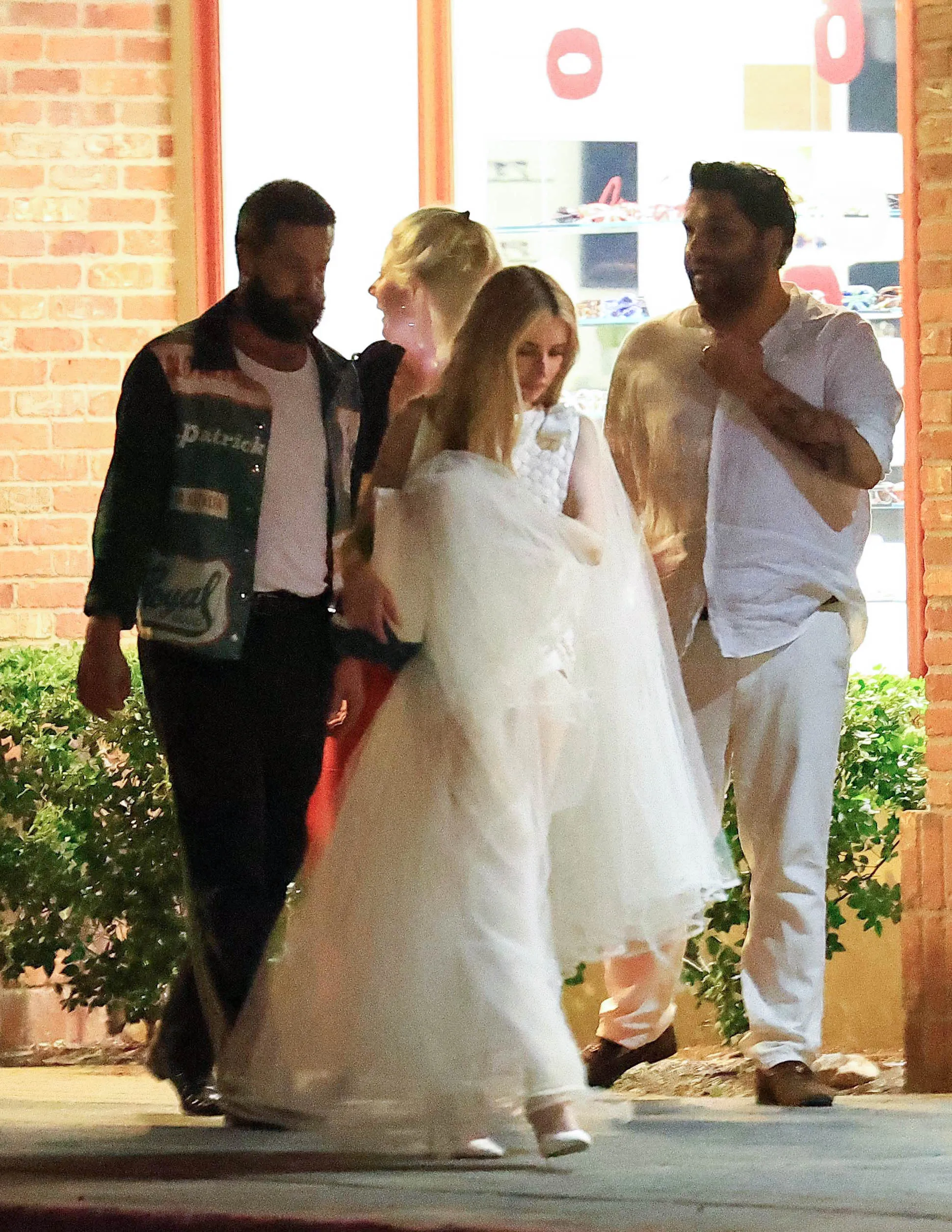 Emma Roberts walking with Cody John and friends after their wedding rehearsal dinner.