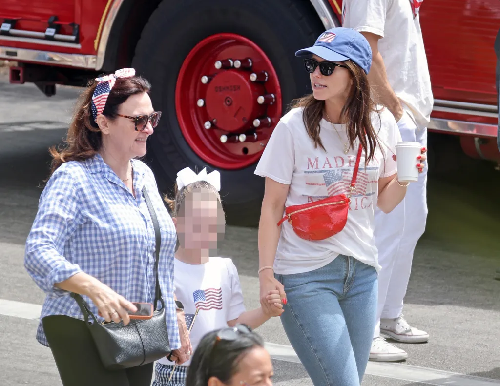Two women and a child at a 4th of July parade.