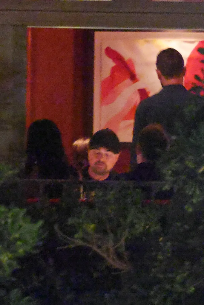 Leonardo DiCaprio and Vittoria Ceretti dining at a restaurant in Saint-Tropez, France.