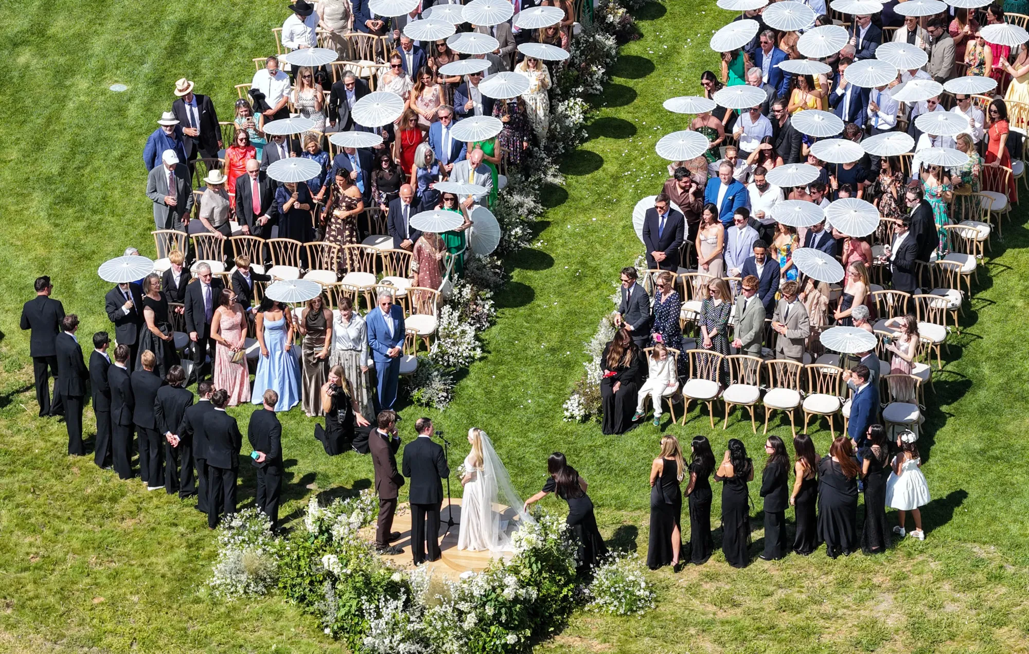 Emma Roberts and Cody John stand at their wedding ceremony, surrounded by guests.