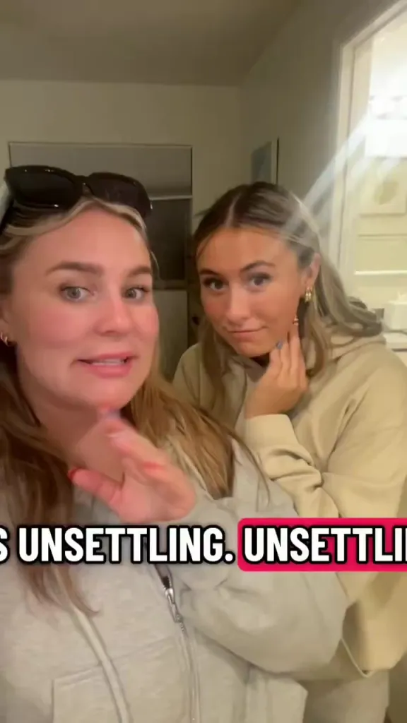 Two young women appear surprised and uncomfortable in a video with the text
