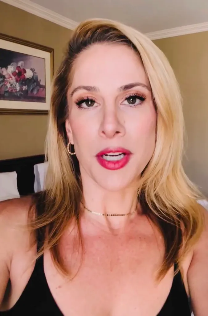 Ana Kasparian, a blonde woman, looking directly at the camera with her mouth slightly open.