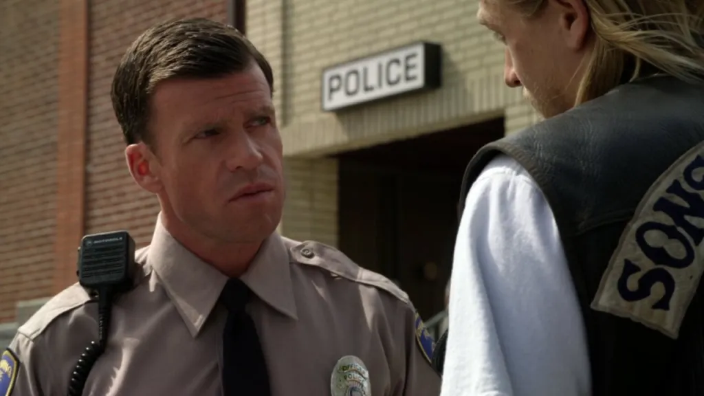 Taylor Sheridan as a police officer in *Sons of Anarchy*.