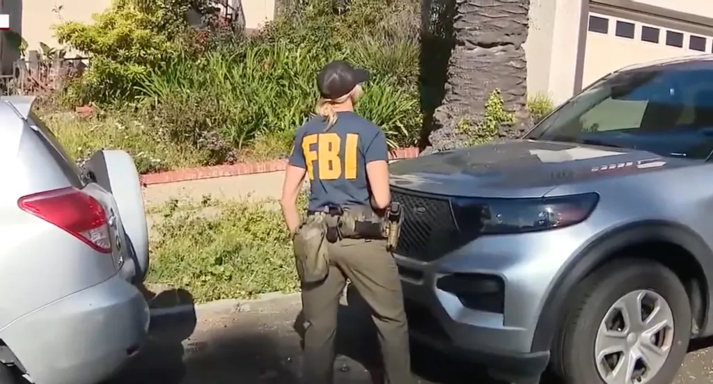 An FBI officer in a dark blue shirt with 