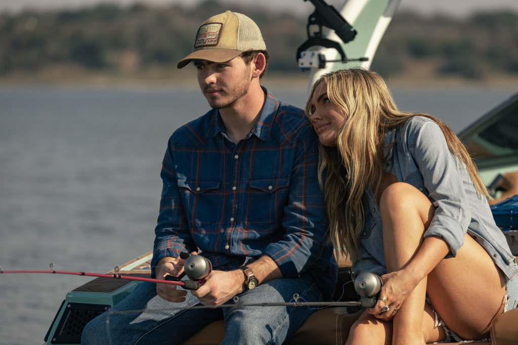 Finn Little as Carter and Natalie Alyn Lind as Oreana fishing on a boat in