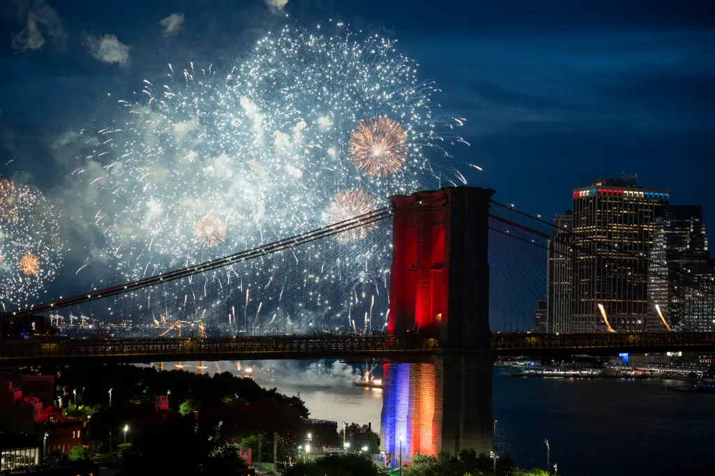 Fireworks light up the sky over the Brooklyn Bridge and Lower Manhattan.