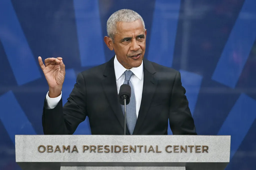 Former US President Barack Obama speaking at a podium with 