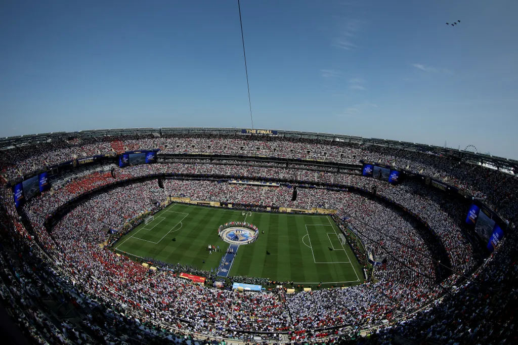 A general view of a soccer stadium packed with fans, with a large