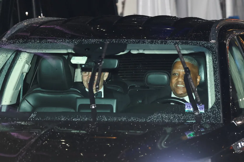 George Stephanopoulos in the back of a vehicle.