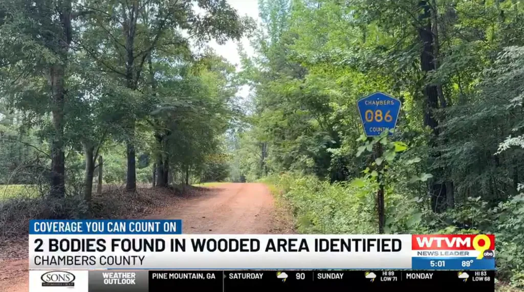 A dirt road cuts through a wooded area with a blue Chambers County sign for route 086 on the right, overlaid with news channel graphics about two bodies found in Chambers County.