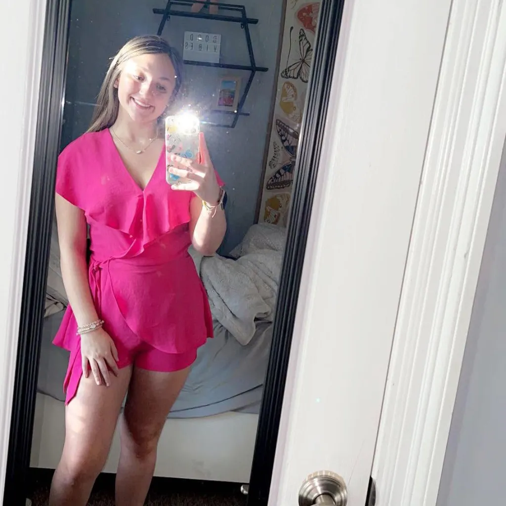 Katie McCormack in a pink romper.