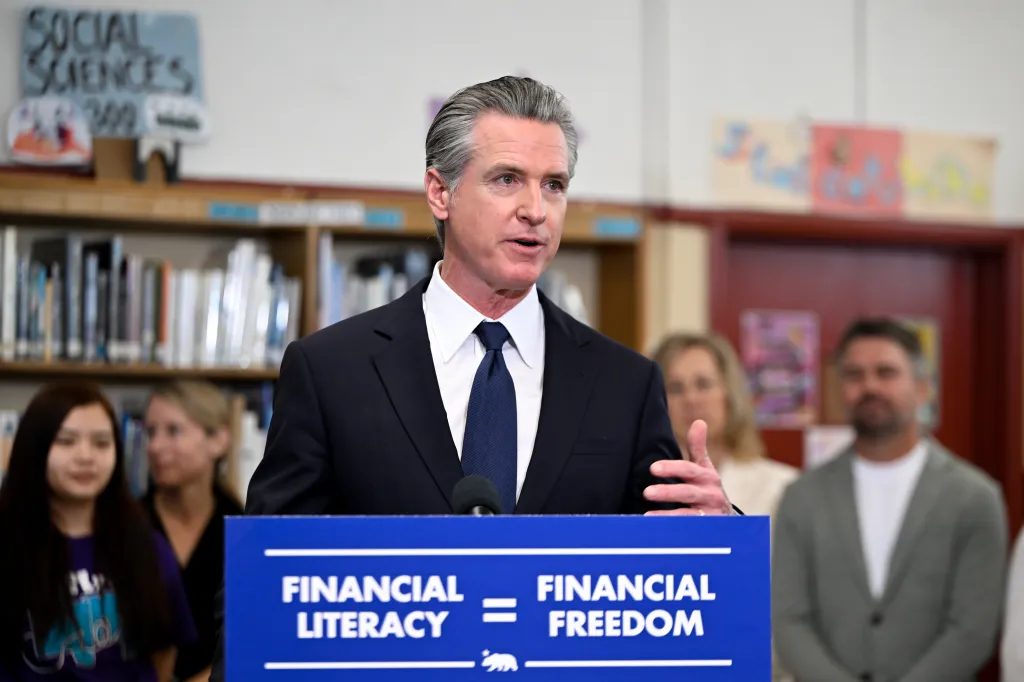 Governor Gavin Newsom speaking at a podium with 