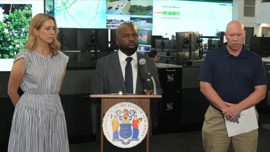Governor Sherrill and two men at a press conference.