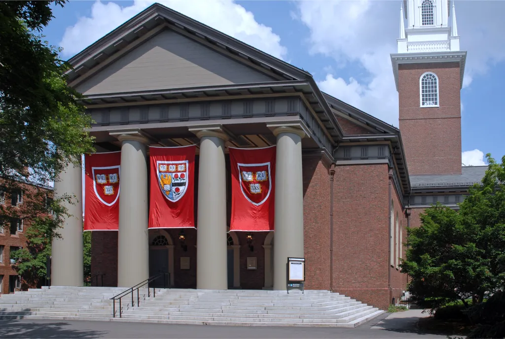 Harvard University Memorial Church, a red brick building with a portico and banners, honoring victims of World War I.
