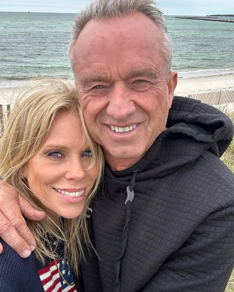 Cheryl Hines and Robert F. Kennedy Jr. embracing by the sea.