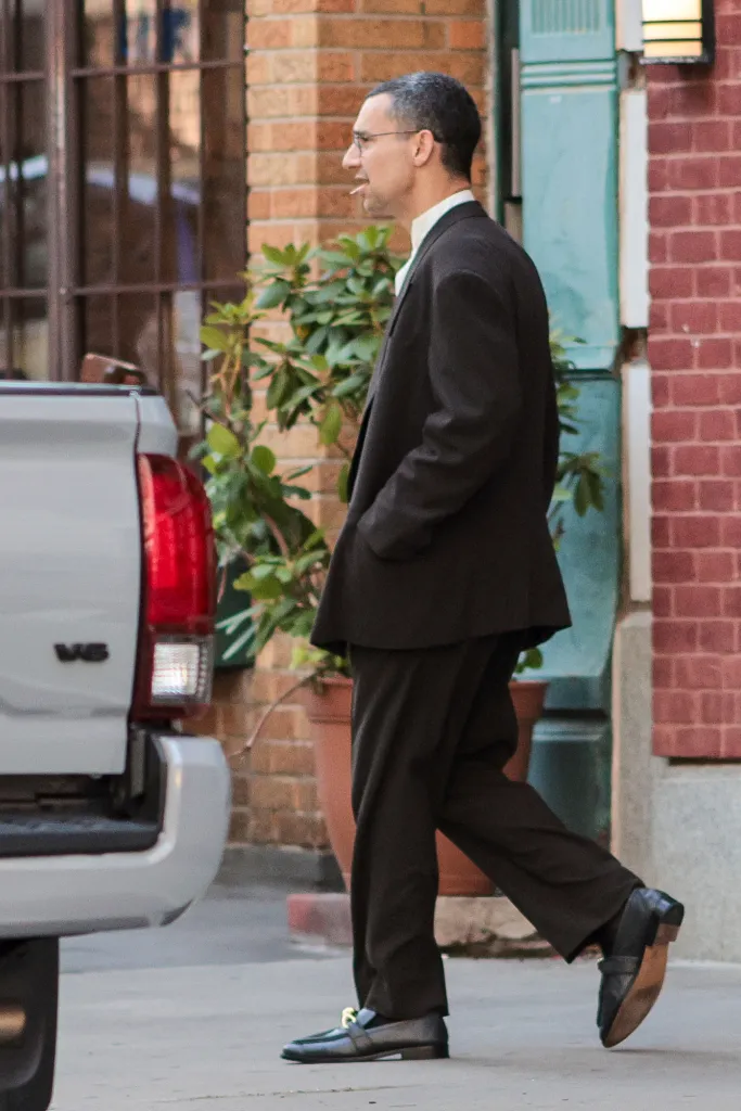 Jack Antonoff walking in a black suit.