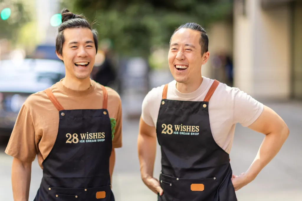 Brothers James and Jason Jiang, wearing black aprons with 