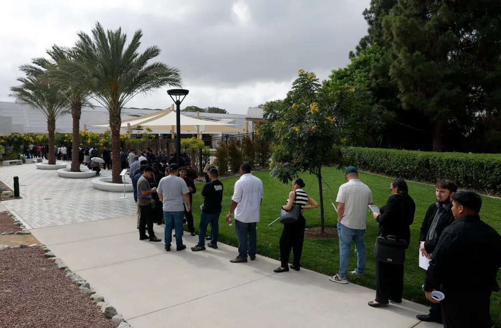 People waiting in line to enter a job fair in Los Angeles.