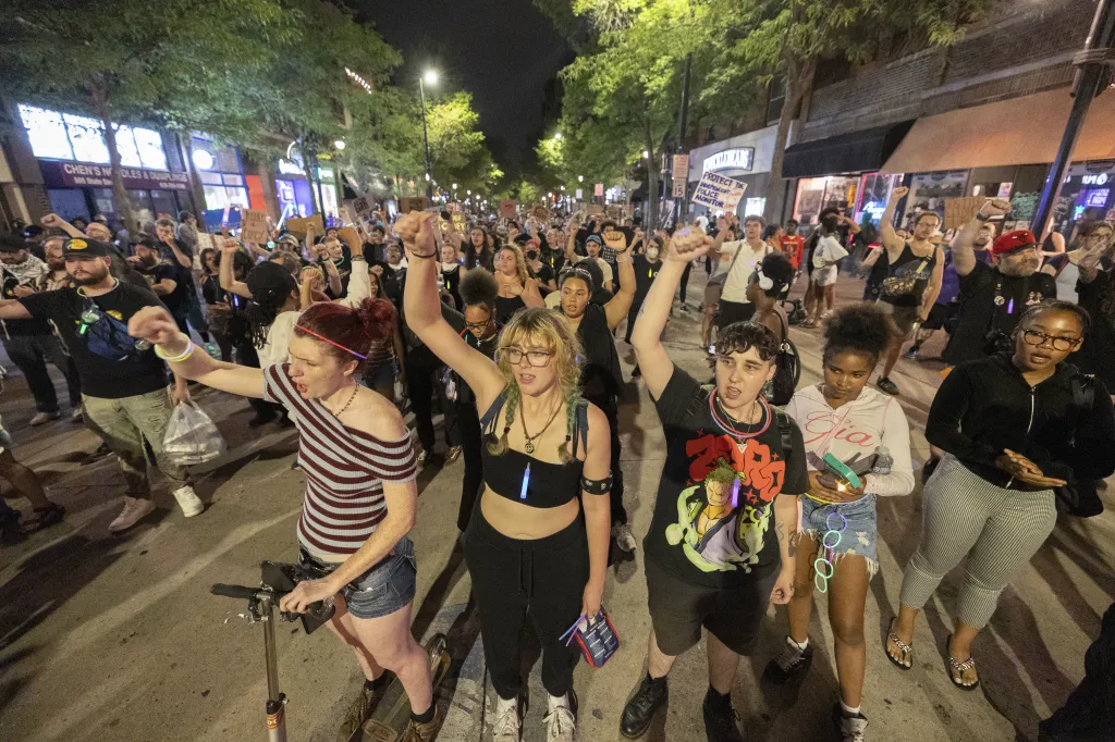 Protesters in downtown Madison raise their fists during a demonstration.