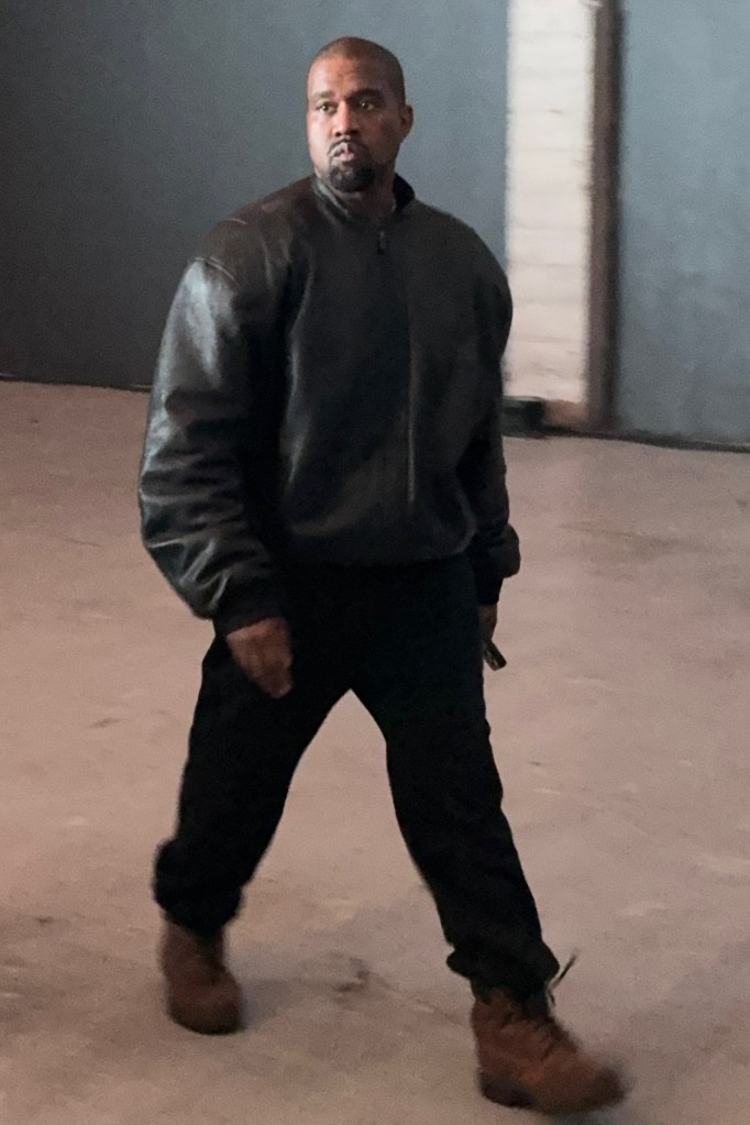 Kanye West walking forward while looking to the right.