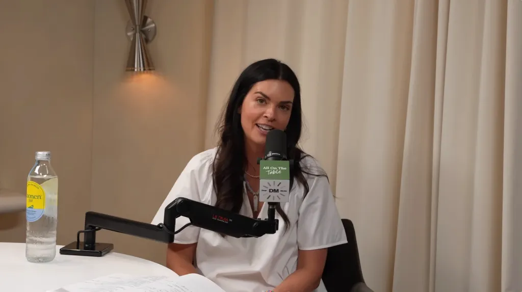 Katie Lee Biegel speaking into a microphone.