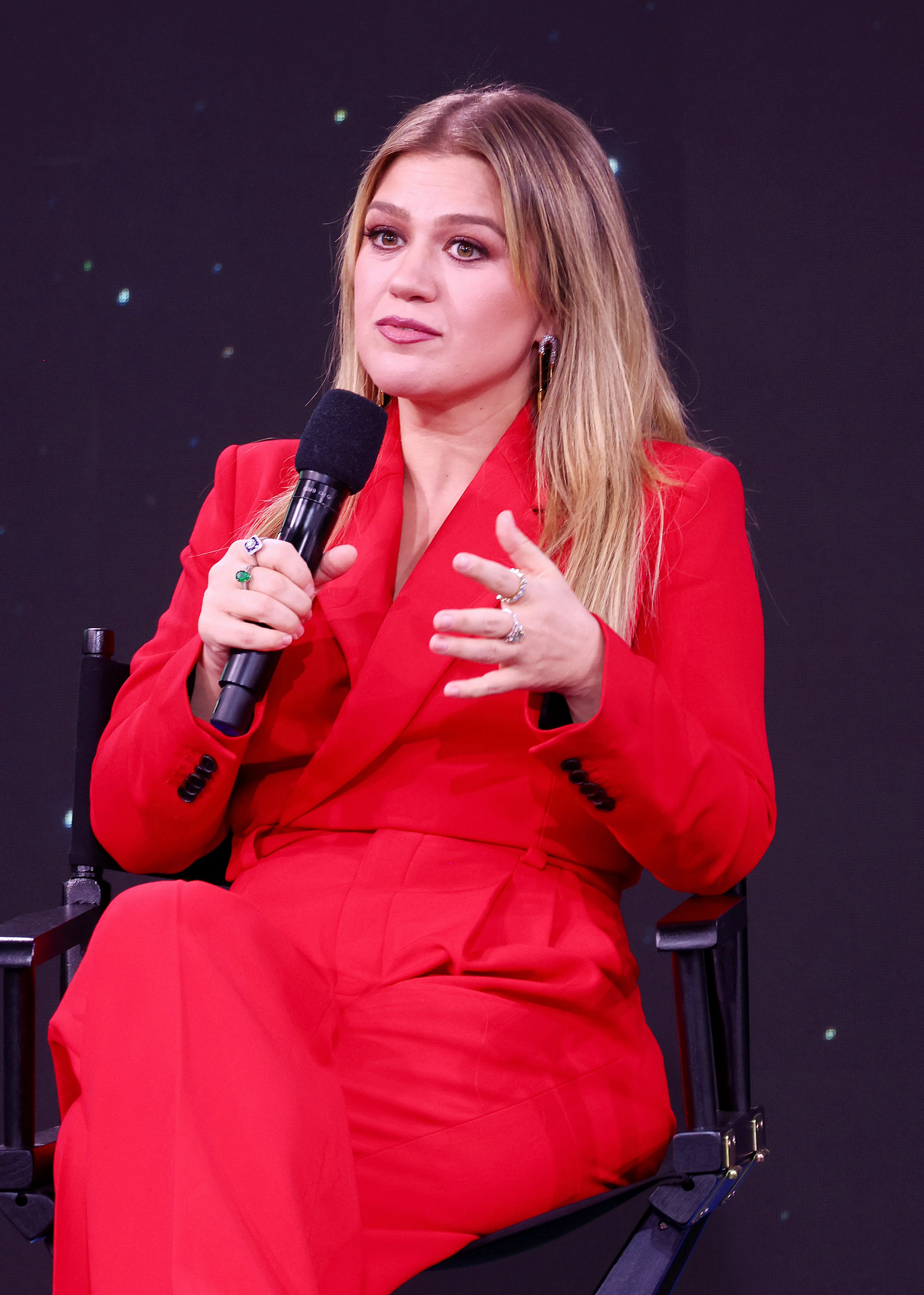 Kelly Clarkson speaking onstage at SiriusXM.