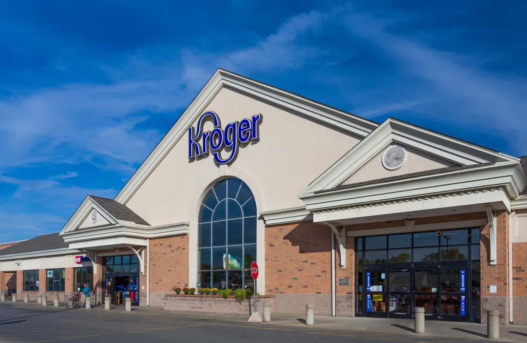 Exterior view of a Kroger grocery store with its blue and white logo on the facade.