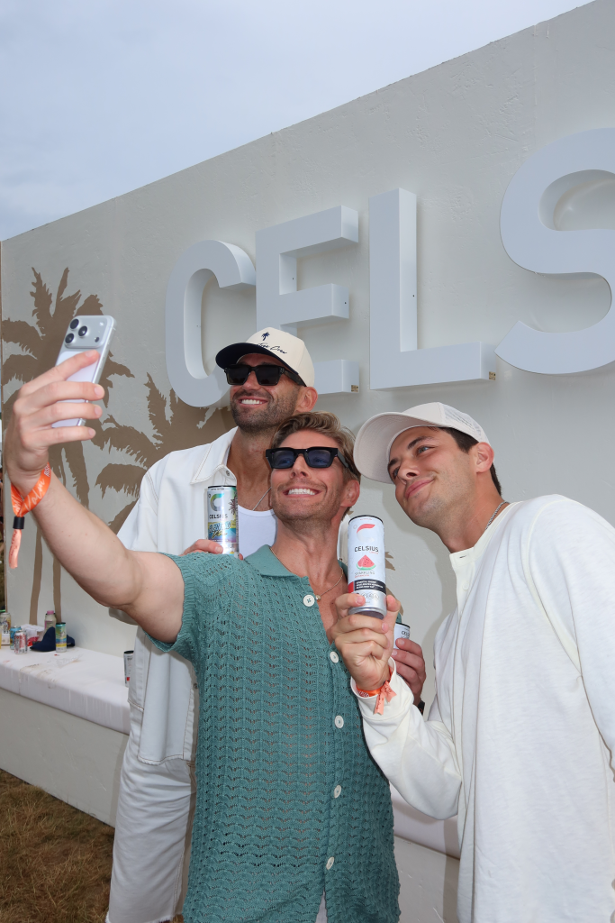 Kyle Cooke and Carl Radke posing for a selfie with Celsius drinks at the Palm Tree Music Festival.