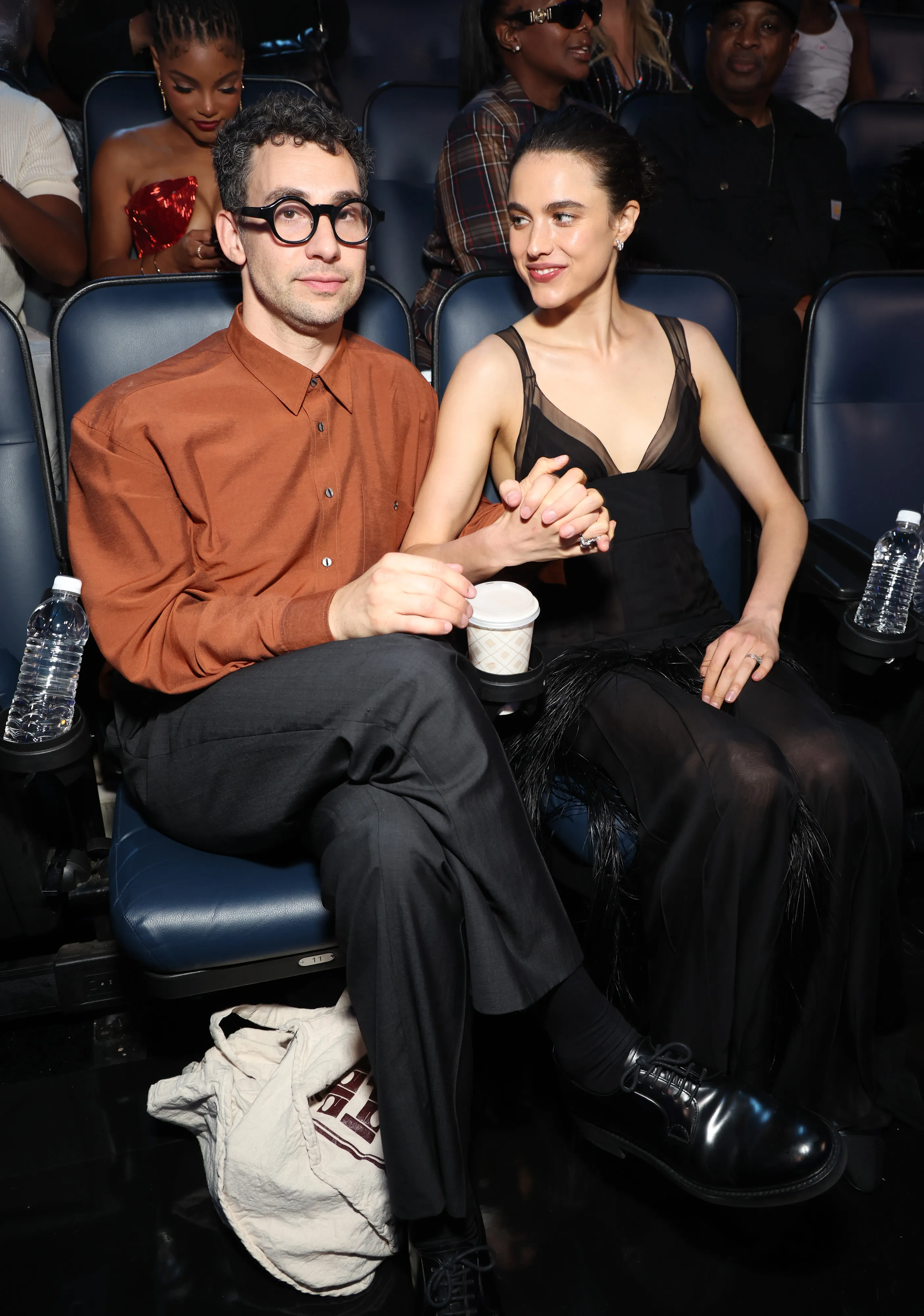 Jack Antonoff and Margaret Qualley holding hands while seated at the 2024 MTV Video Music Awards.