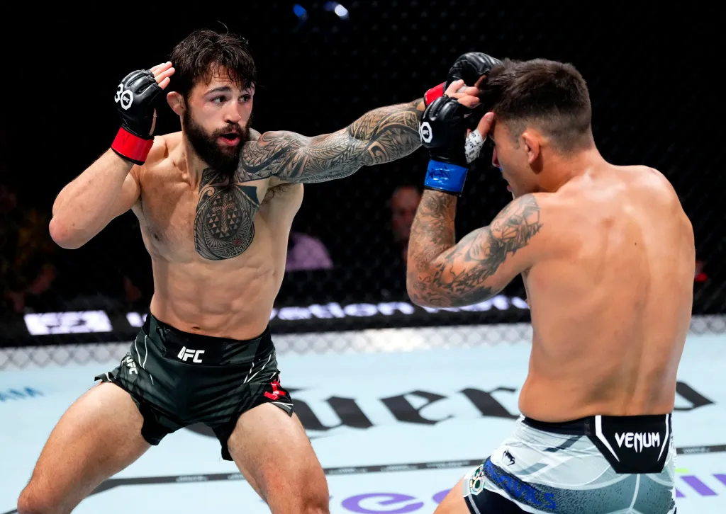 Kamuela Kirk punching Esteban Ribovics during UFC 290.