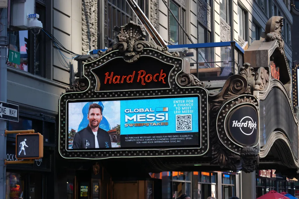 A Lionel Messi sweepstakes advertisement on the Hard Rock Cafe marquee in Times Square.