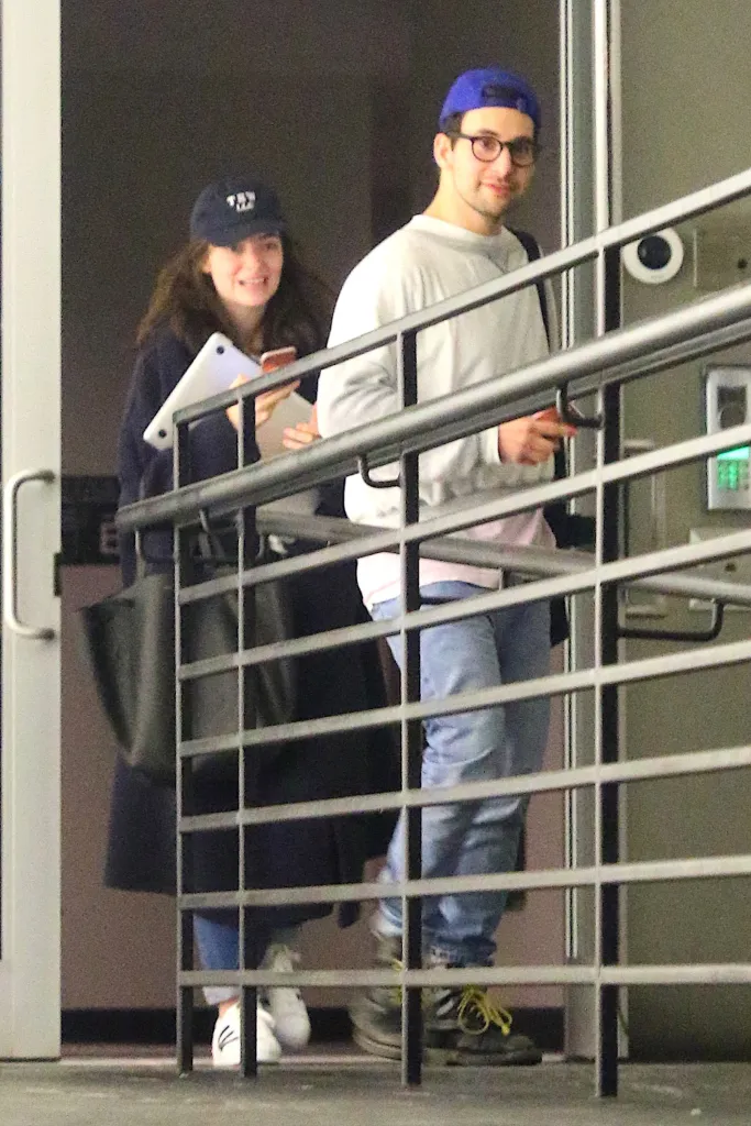 Lorde and Jack Antonoff smiling, with Lorde in a black trench coat and Jack Antonoff in a white sweatshirt.