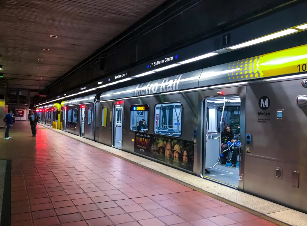 A Los Angeles Metro Rail Expo Line train at the 7th St/Metro Center station platform with people exiting.