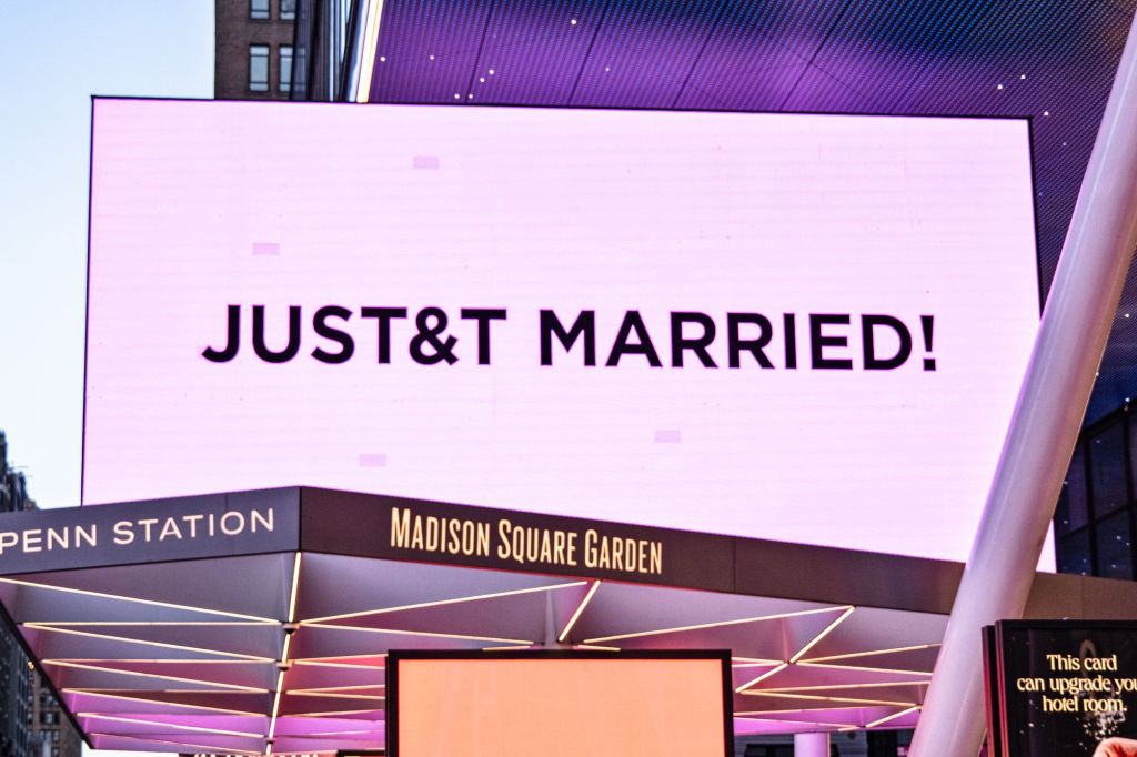 A digital billboard at Madison Square Garden lit in pink with the text 