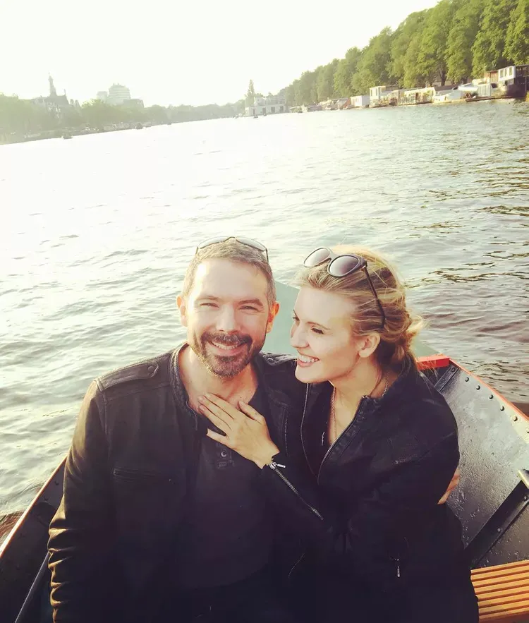 Maggie Grace and Brent Bushnell on a boat, with Maggie's arm around Brent and her hand on his chest.