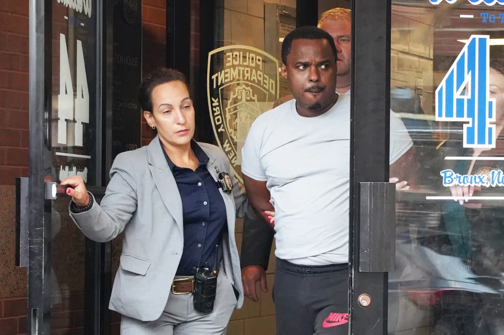 William Ferrer being escorted by two detectives from the 44th Precinct in the Bronx, New York.