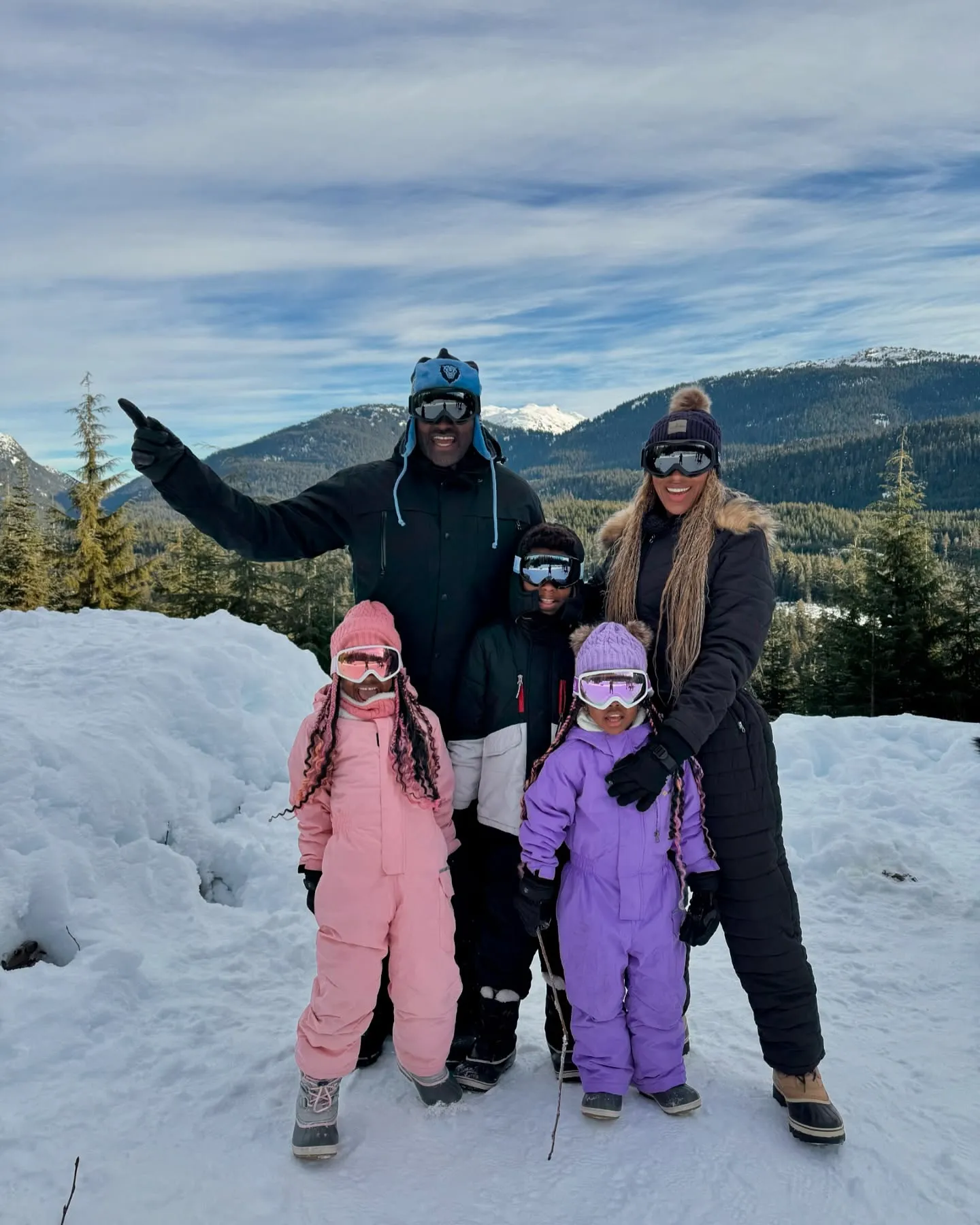 Marcellus Wiley and Annemarie Wiley with their children in winter gear on a snowy mountain.