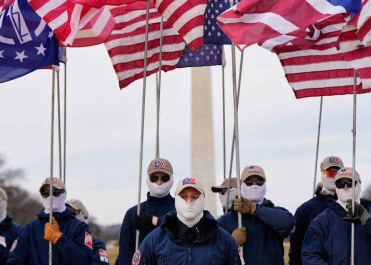 Demonstrators in white supremacist attire protest on Capitol Hill