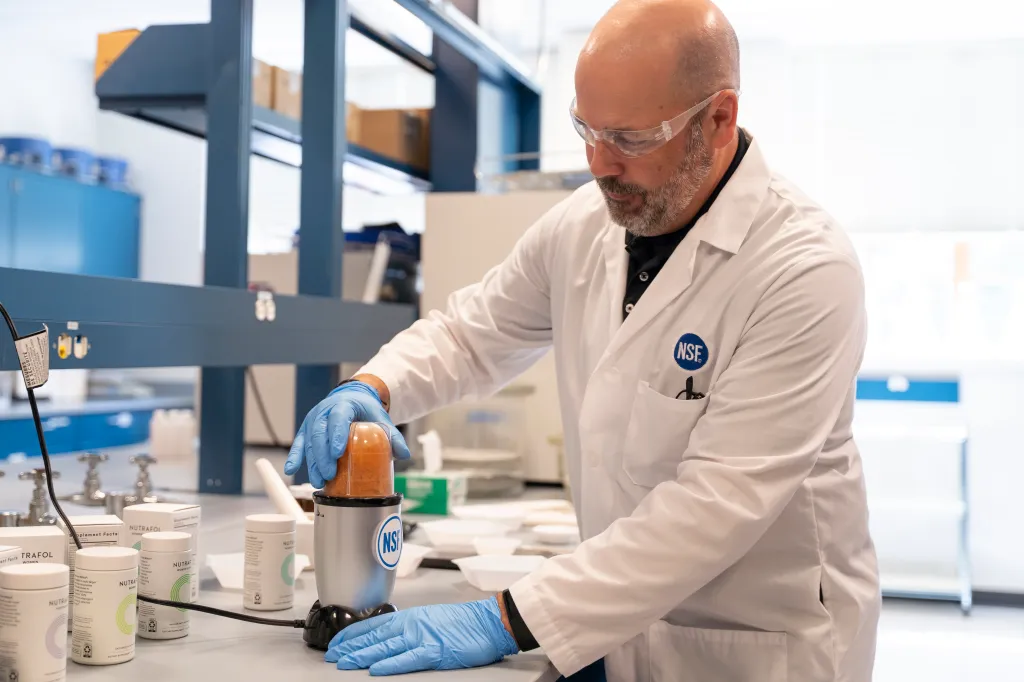 Scientist Mike Harvey grounds Nutrafol capsules for analysis at NSF Labs.