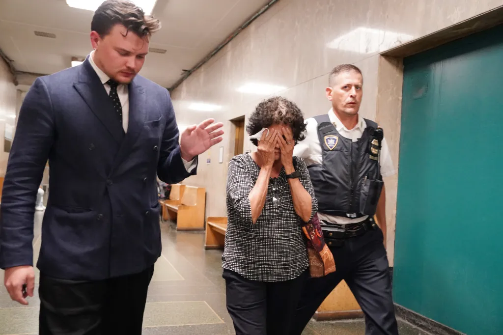 Raul Morales' mother covers her face as she leaves Manhattan Criminal Court on July 24, 2026.