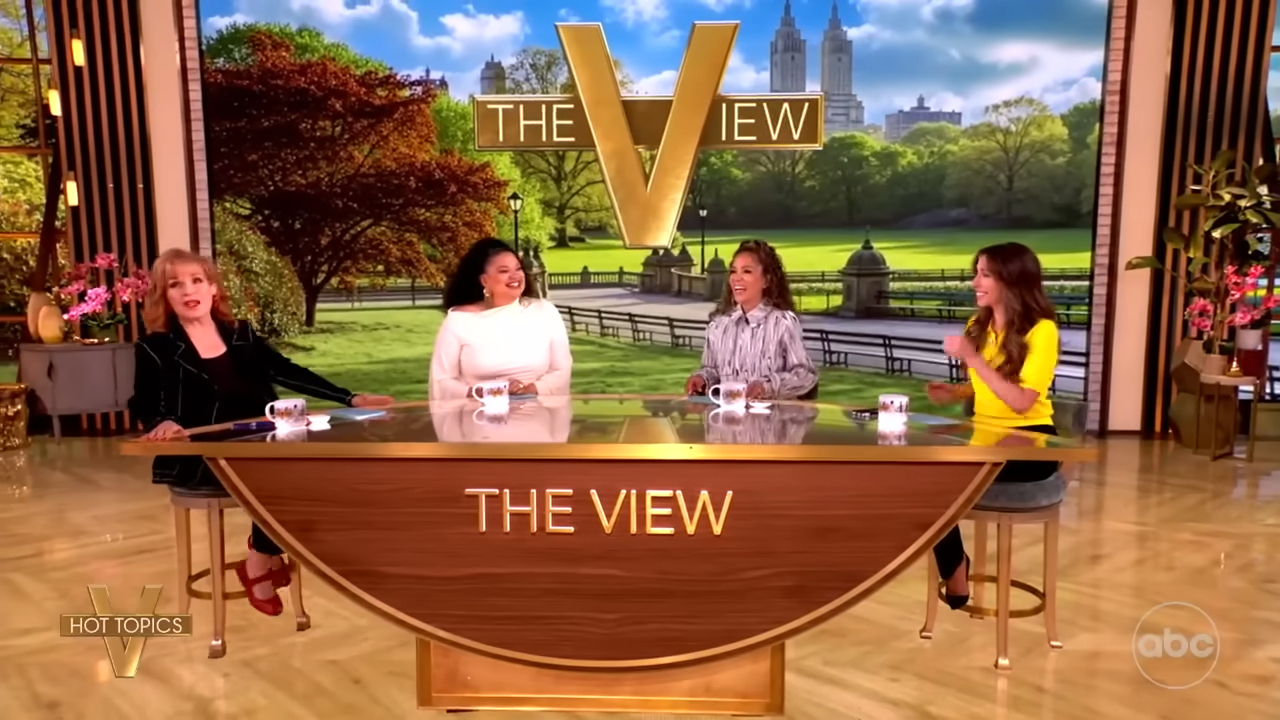 Four women sitting at a desk with 
