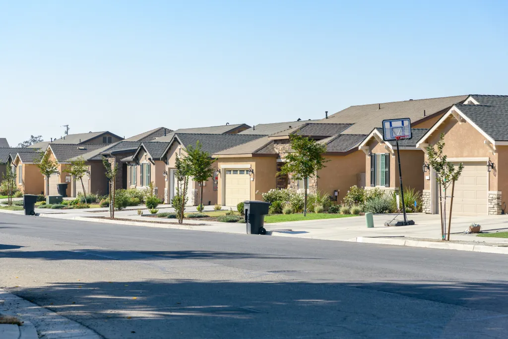 Newly built suburban houses along a street in Visalia, CA.