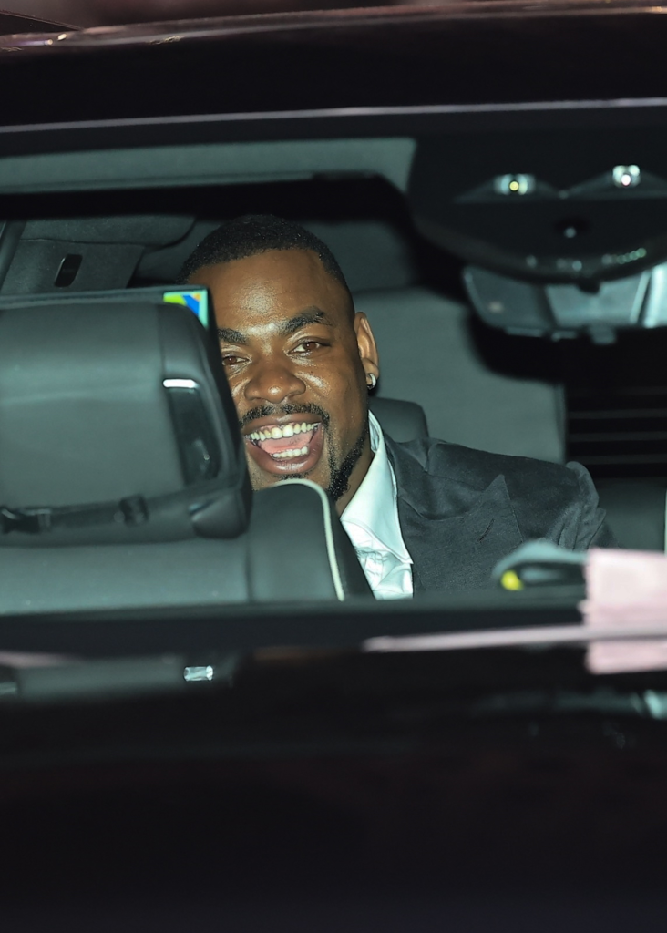 Chris Jones laughing from the back seat of an SUV.