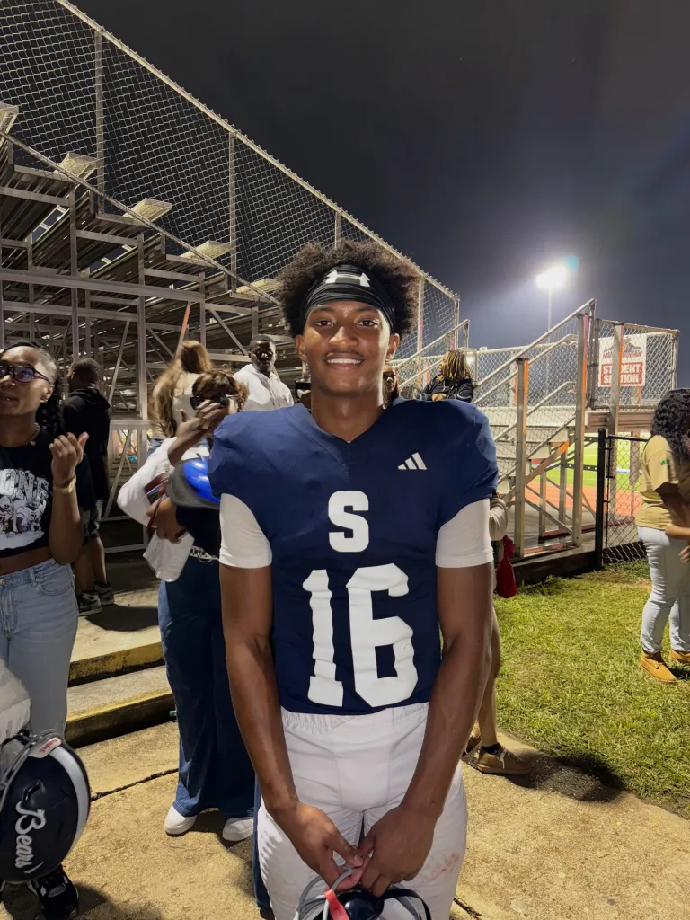 Nolan Wells in a football uniform on a field at night.