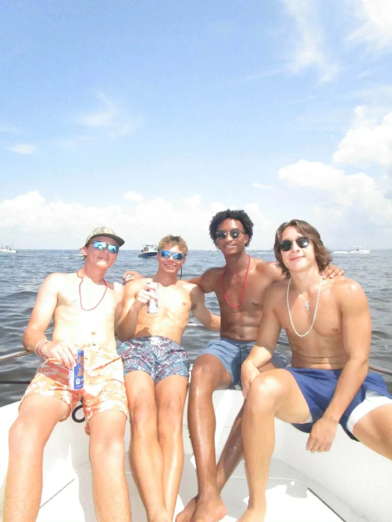 Nolan Wells, second from right, with friends on a boat during July 4 celebrations.