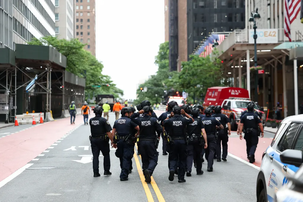 NYPD officers walk outside a building on 42nd Street in New York City reported to have structural issues.