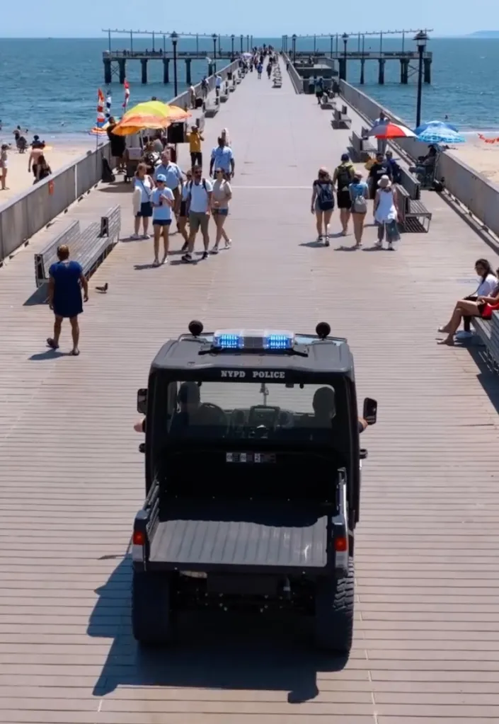NYPD Police vehicle on a pier tracking sharks.