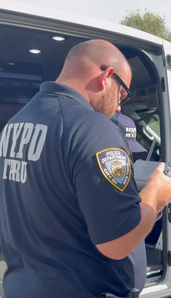 An NYPD officer operating a drone controller.