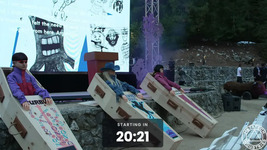 Oliver Tree's Celebration of Life event features a large screen with a cartoonish monster and text, three open coffins with mannequins, and a bison prop, with a 